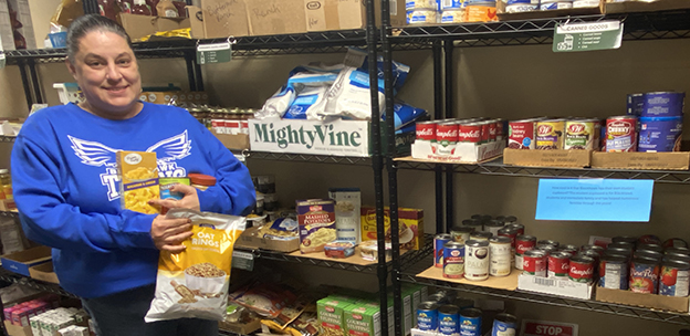 Student stocking items in the Student Cupboard